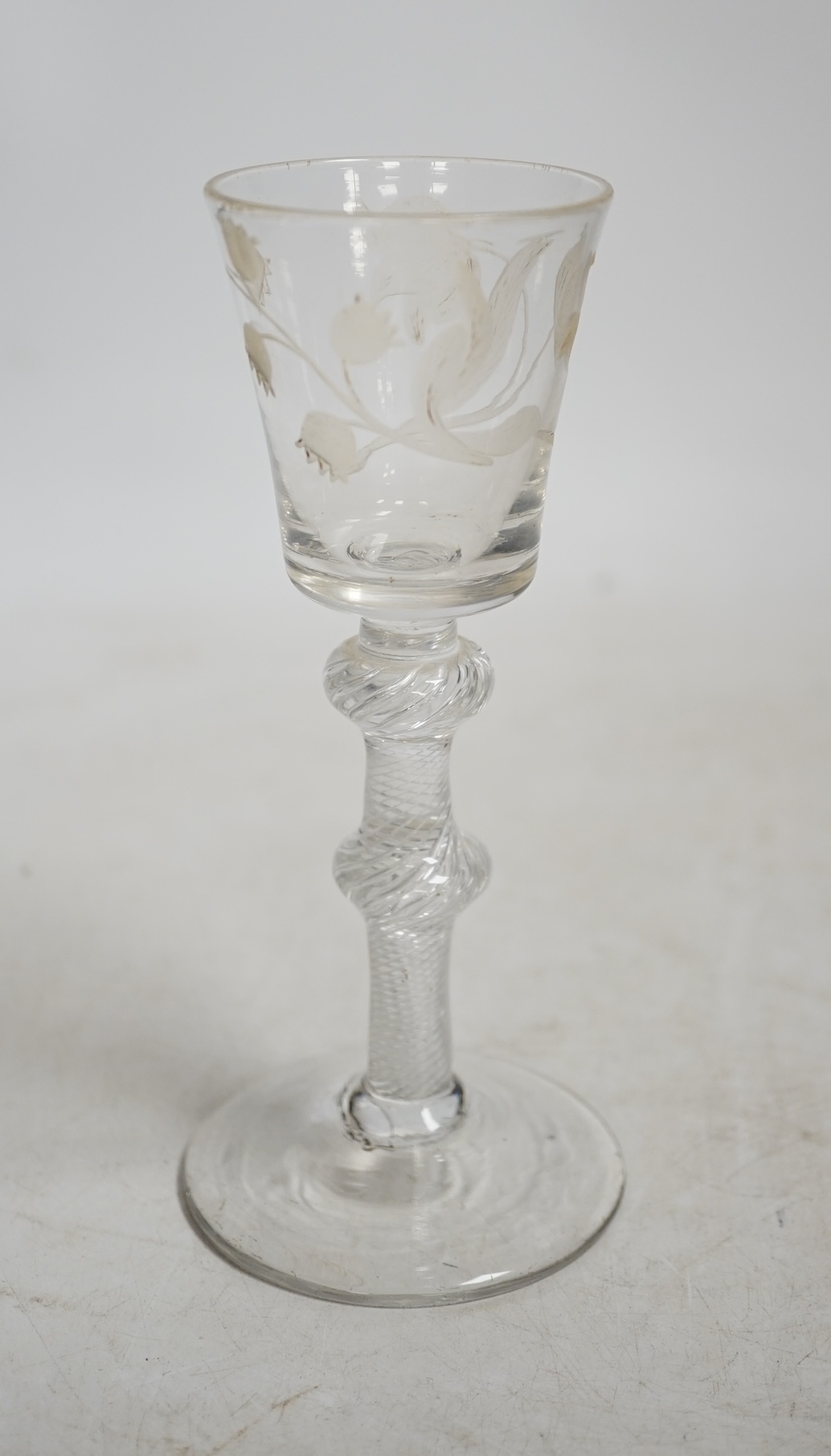 A mid 18th century air twist stem cordial glass with later engraved decoration, 15.5cm high. Condition - fair